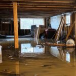 An image of a flooded basement. Belongings are floating in about a foot of water.
